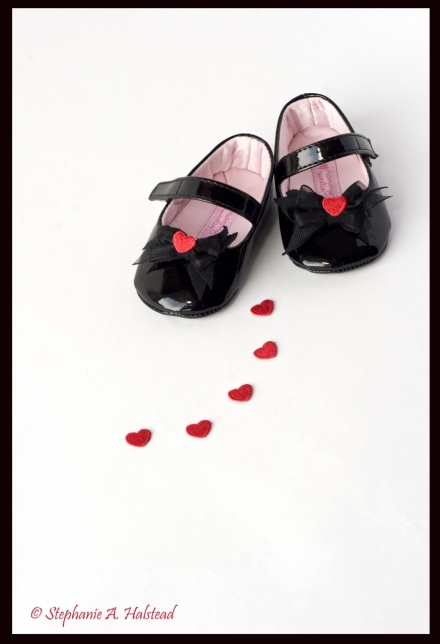 "Heart and Soles".  Little girl's black shoes.  Photo of children shoes